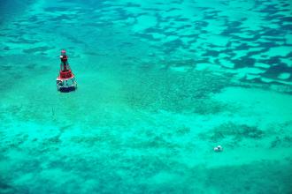 Lighthouse in the middle of turquoise blue ocean