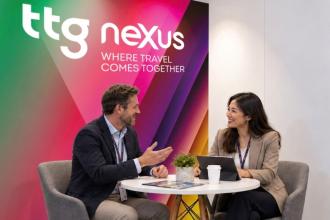 Two people meeting at TTG Nexus within a booth